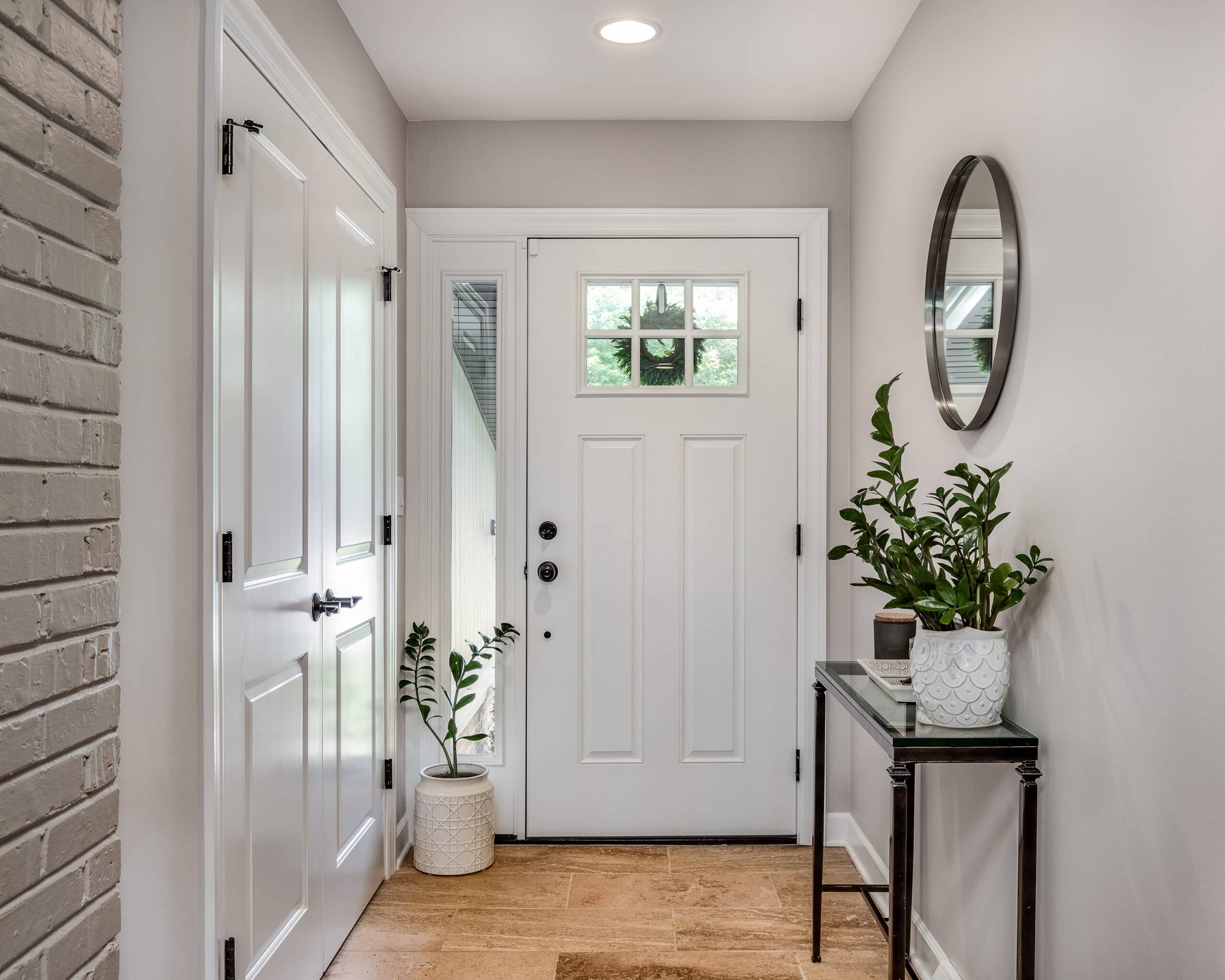 A cozy entryway with brown walls and a white front door.